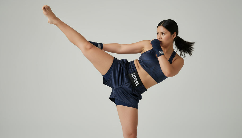 Woman in navy athletic wear with 'Lorna Jane' branding, performing a high leg lift against a plain background.